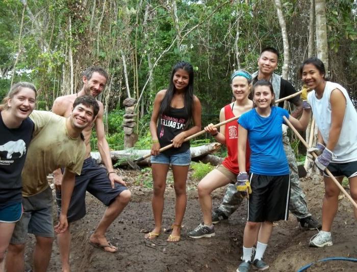 Eight Saint Mary's students posing for the photo with trees from the Brazilian rain forest in the background